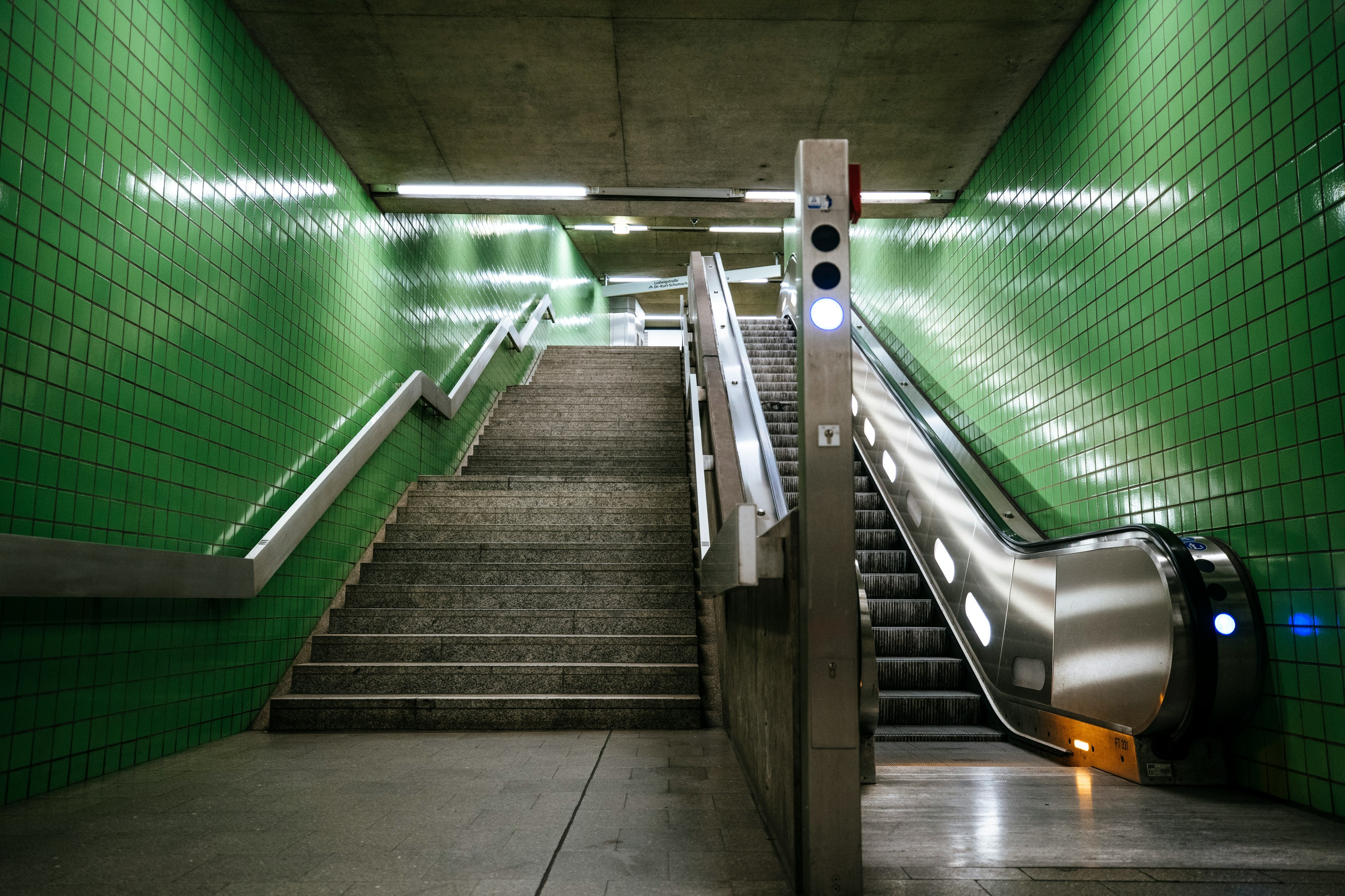 gray concrete stairs with green metal railings